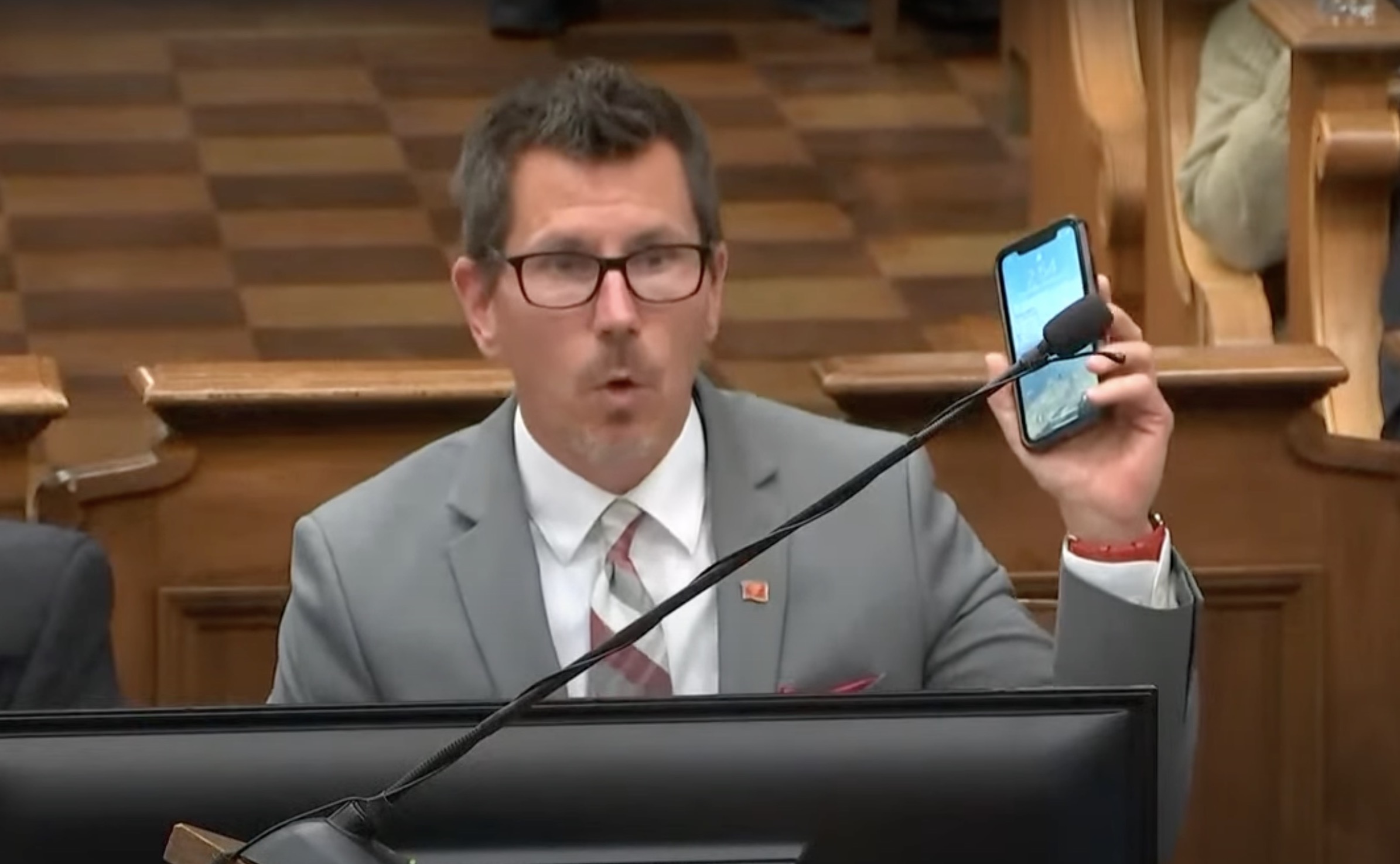 Technology Kenosha County prosecutor Thomas Binger holds up his iPhone while arguing that pinch-to-zoom should be allowed when showing video during cross-examination in this screenshot from the Washington Post's livestream.