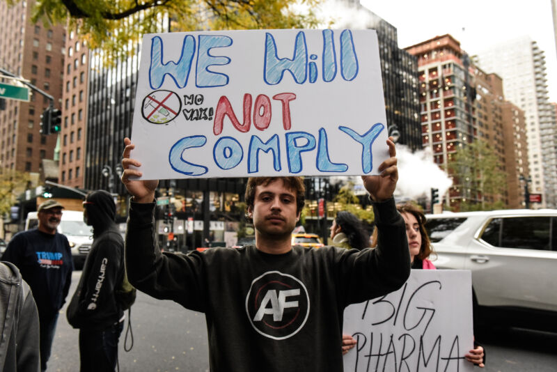 People associated with the far-right group America First attend an anti-vaccine protest in front of Pfizer world headquarters on November 13, 2021, in New York City.