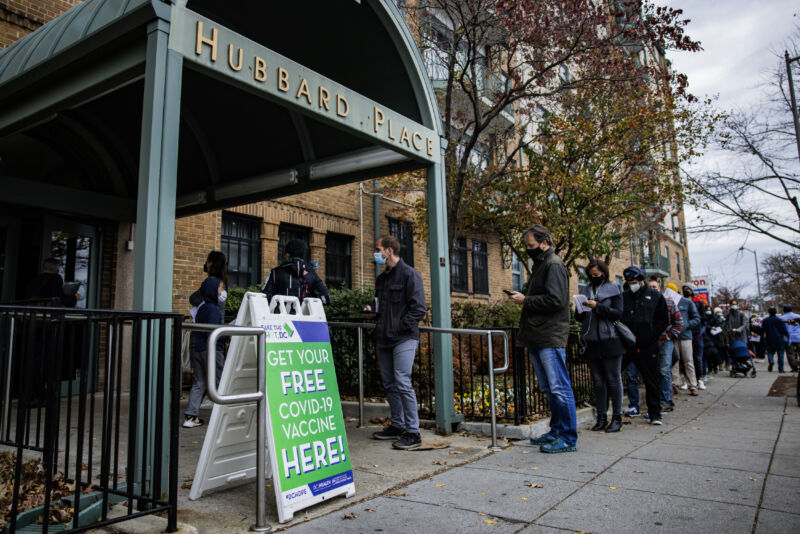 People line up outside of a free COVID-19 vaccination site that opened today in the Hubbard Place apartment building on December 3, 2021 in Washington, DC. 