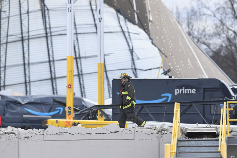 Technology A first responder walks among the wreckage of a damaged Amazon warehouse on December 11, 2021, in Edwardsville, Illinois.