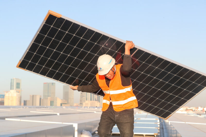 Man carrying a solar panel