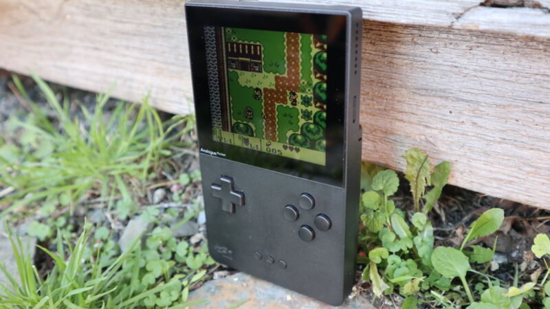 Analogue Pocket handheld game system posed in an outdoor scene