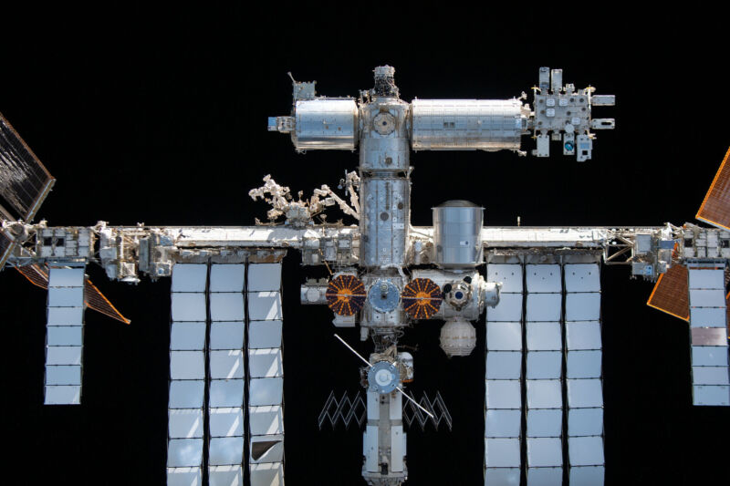 The International Space Station, as seen in November 2021. Prominent at center in this view are the cymbal-shaped UltraFlex solar arrays of the Northrop Grumman Cygnus space freighter.