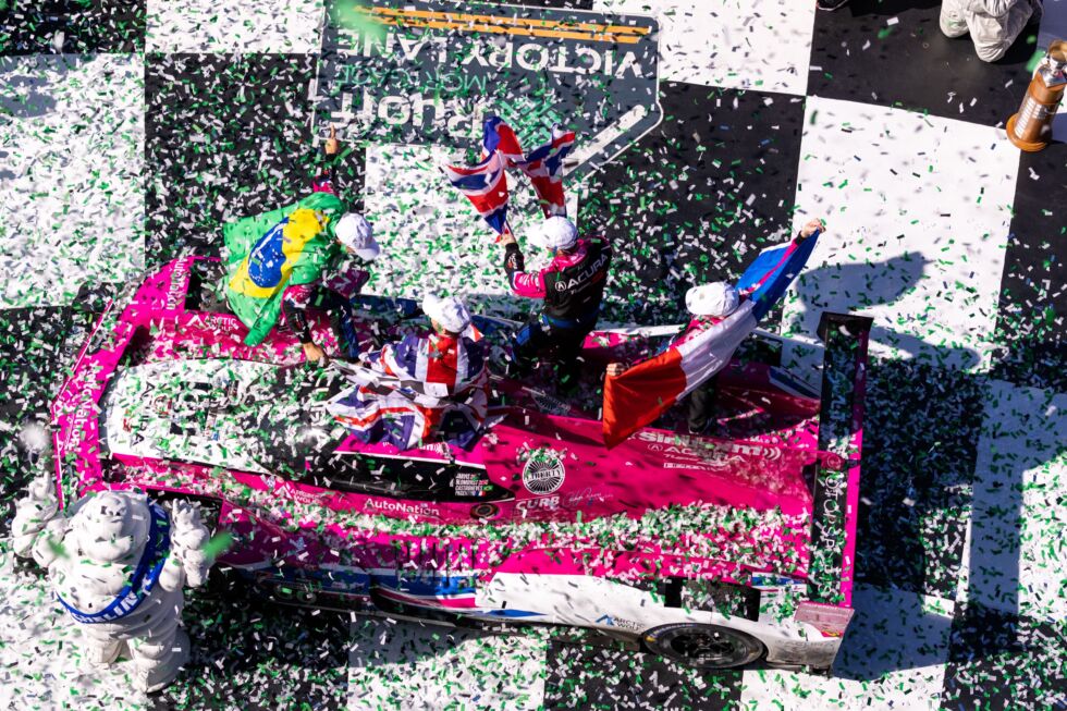 The No. 60 Meyer Shank Racing team celebrates winning the 60th running of the Rolex 24 under a flurry of confetti.