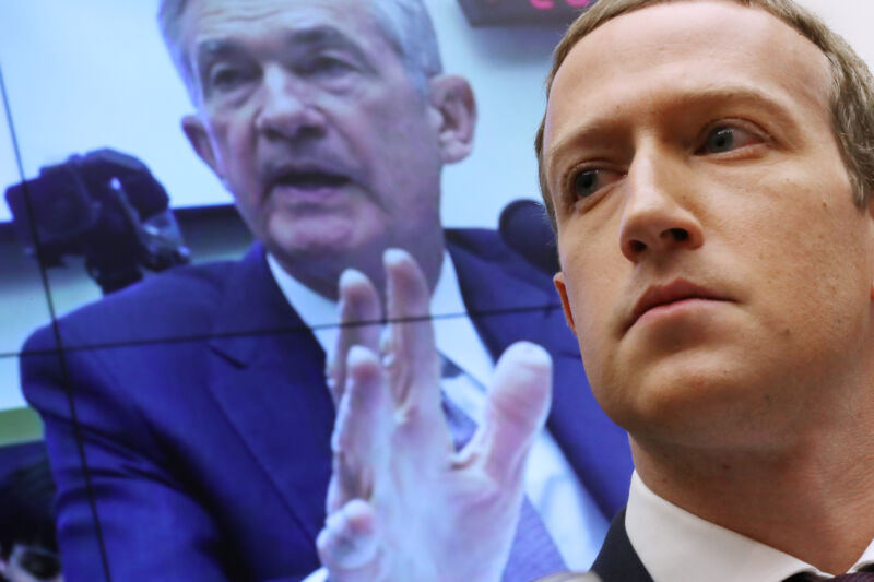 With an image of Federal Reserve Bank Chairman Jerome Powell on a screen in the background, Facebook/Meta co-founder and CEO Mark Zuckerberg testifies before the House Financial Services Committee on October 23, 2019, in Washington, DC.