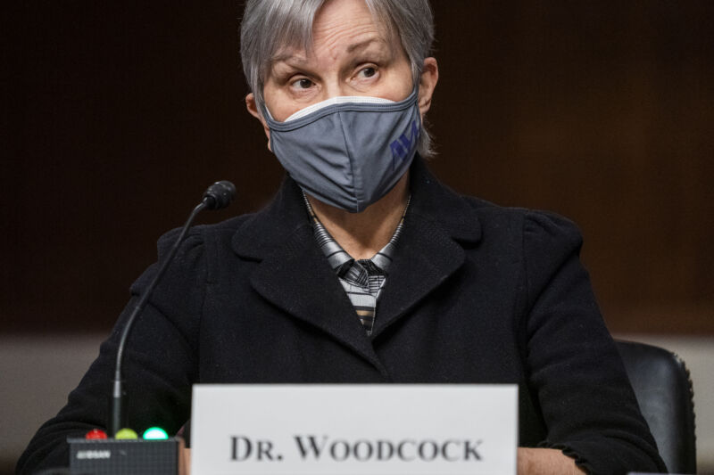 A masked woman with a gray bob.