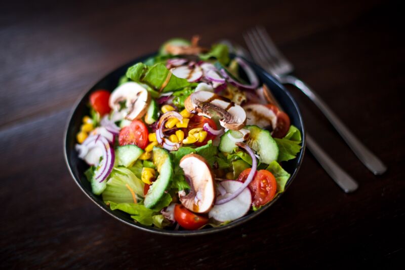 Mushrooms, corn, and tomatoes make this more than a green salad.