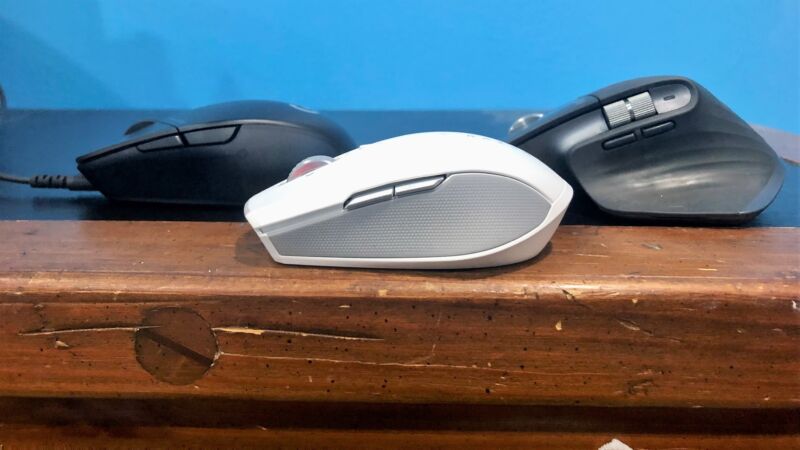 Three mice on a wooden table.