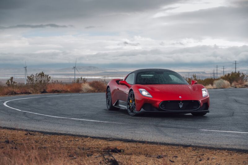 a red Maserati MC20 in the rain