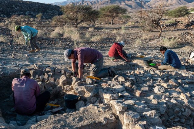 Archaeologists excavating a Bronze Age and Iron Age settlement near the village of Ayn Bani Saidah in Oman. 