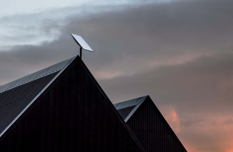 A Starlink satellite dish mounted on a roof.