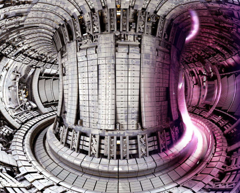 The interior of JET, configured as a scale model for ITER, overlaid with an image of a plasma present in the tokamak during experiments.