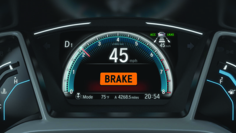 Promotional image of Honda dashboard while warning system is activated.