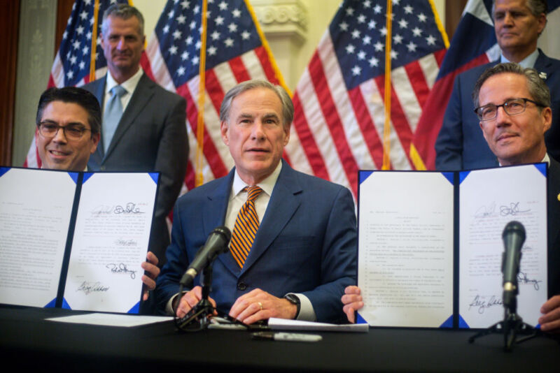 Texas Governor Greg Abbott, center, during a press conference at the Capitol on June 8, 2021, in Austin, Texas. He signed two bills into law to reform the Electric Reliability Council of Texas.