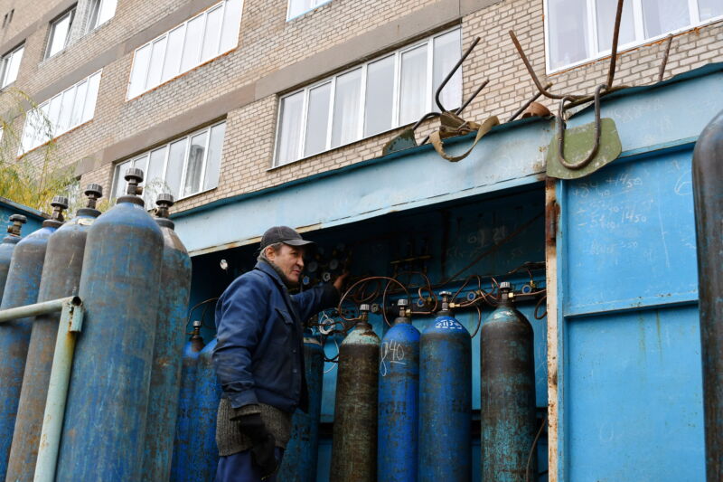 A worker is seen servicing oxygen cylinders for COVID-19 patients in Kramatorsk city hospital. 