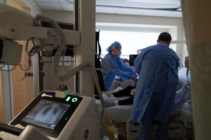 X-ray technicians take a chest X-ray of an unvaccinated COVID-19 patient on the Intensive Care Unit (ICU) floor at Hartford Hospital in Hartford, Connecticut, U.S., on Tuesday, Feb. 1, 2022. 