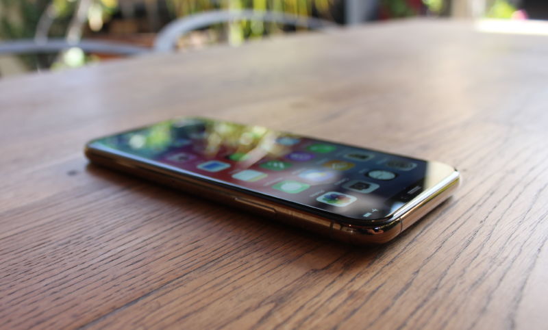 A smartphone on a wooden table.