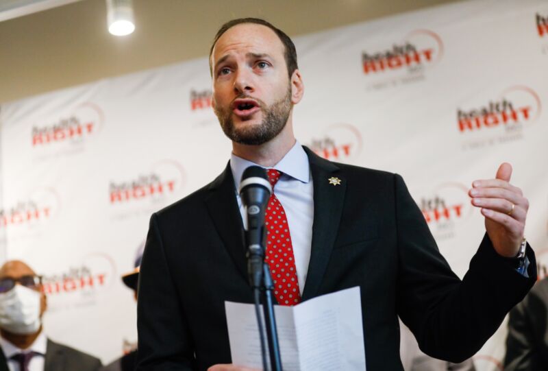 San Francisco District Attorney Chesa Boudin standing and speaking into a microphone.