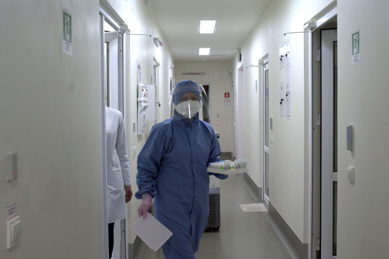 A health care worker carries test tubes while on duty in the bacteriological laboratory at the Lviv Regional Laboratory Centre of the State Sanitary and Epidemiological Service, Lviv, western Ukraine. 