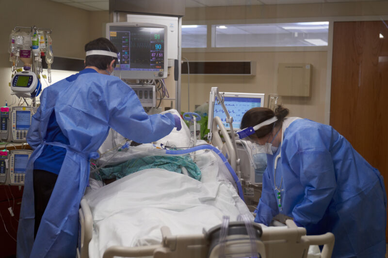 Health care workers treat a COVID-19 patient at Hartford Hospital in Hartford, Connecticut, on Monday, Jan. 31, 2022. Photographer: Allison Dinner/Bloomberg via Getty Images.