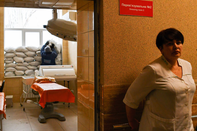 A nurse waits as another staff places sand bags near the window for protection in Kramatorsk City Hospital in eastern Ukraine. 