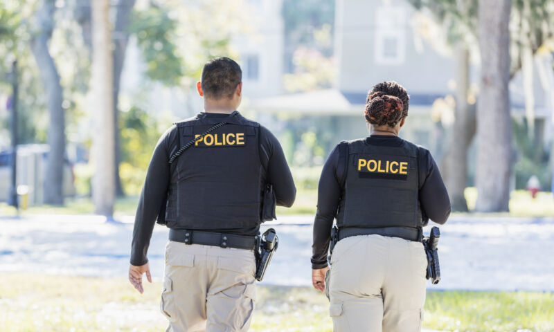 Image of two police officers in a neighborhood.