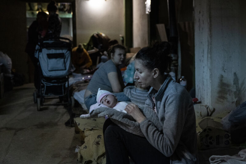 KYIV, UKRAINE - FEBRUARY 28: A mother tends to her baby under medical treatment in the bomb shelter of the pediatric ward of Okhmatdyt Children's Hospital on February 28, 2022 in Kyiv, Ukraine. 