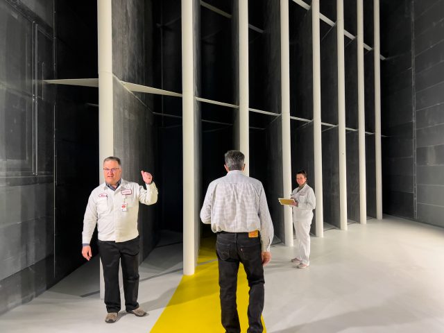 People stand in front of turning vanes inside HALO's wind tunnel