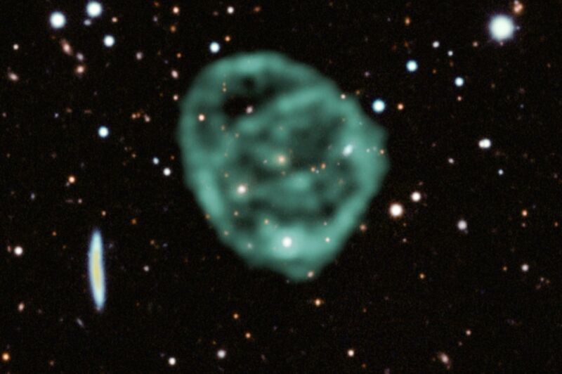 Data from SARAO's MeerKAT radio telescope data (green) showing the odd radio circles, is overlaid on optical and near infrared data from the Dark Energy Survey. 