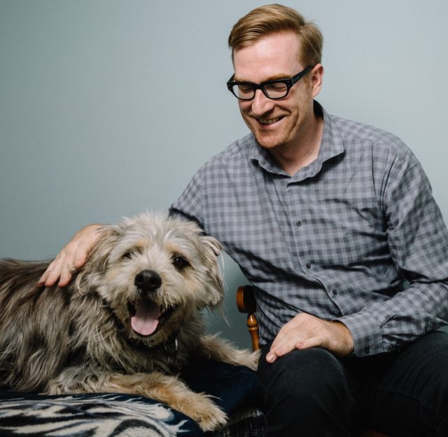 <em>Dinosaur Comics</em> creator Ryan North with his trusty canine companion, Noam Chompsky. Ryan's latest book is <em>How to Take Over the World: Practical Schemes and Scientific Solutions for the Aspiring Supervillain.</em>