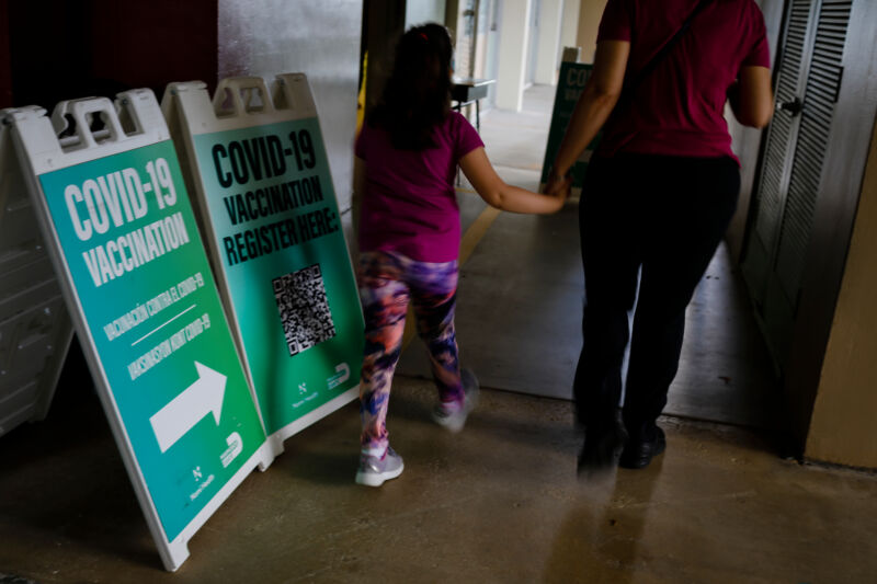 A child arrives at an elementary school vaccination site for children ages 5 to 11 in Miami in November 2021. 