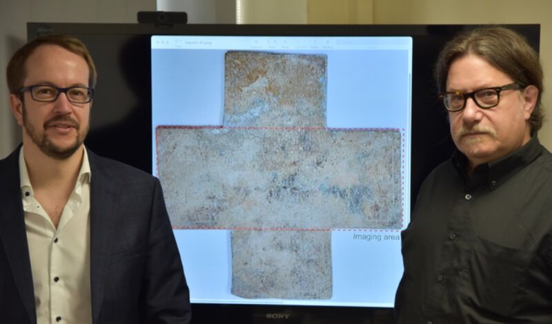 Georgia Tech's Alexandre Locquet (left) and David Citrin (right) with an image of the 16th-century funerary cross used in their study.