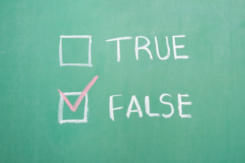 True and false written on a chalkboard with a check mark next to false.