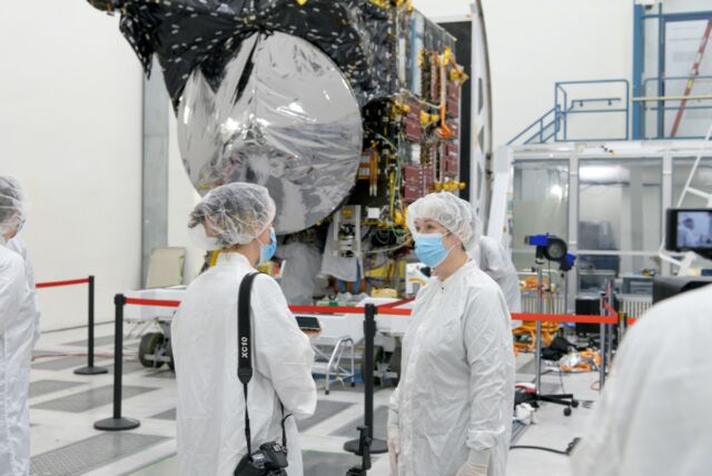 Underneath all that clean-room gear is Linda Elkins-Tanton of Arizona State University (right), Psyche principal investigator, chatting with a reporter in front of the actual spacecraft. 