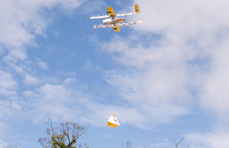 A drone from Alphabet's Wing delivers a package to a customer.