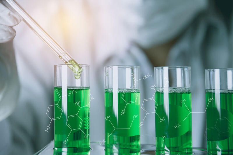 Image of green colored solutions in glass vials.
