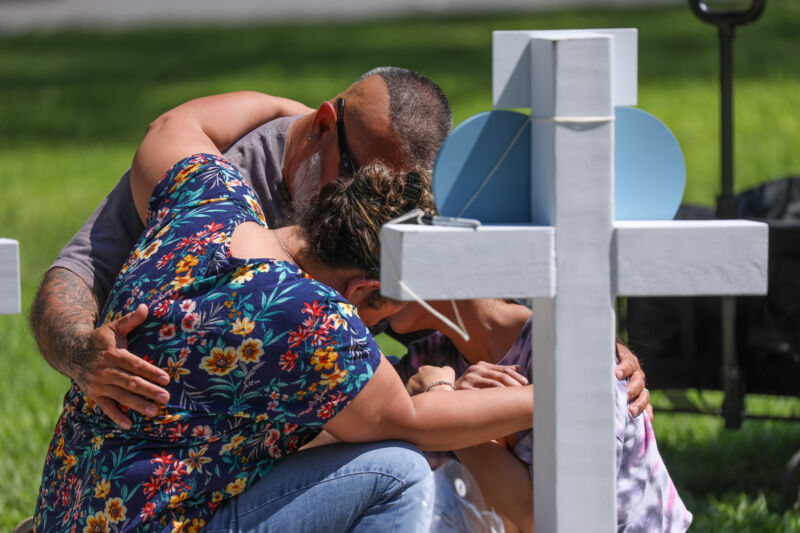 Mourners visit a memorial for victims of Tuesday's mass shooting at an elementary school in Uvalde, Texas.