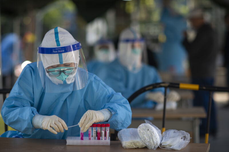 A medical worker arranges nucleic acid samples at a makeshift nucleic acid testing site on May 3, 2022 in Beijing, China.