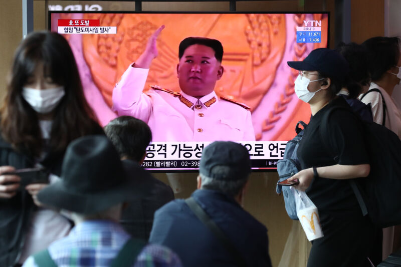 People watch a television broadcast showing a file image of North Korean leader Kim Jong Un during a military parade at the Seoul Railway Station on May 4, 2022 in Seoul, South Korea.