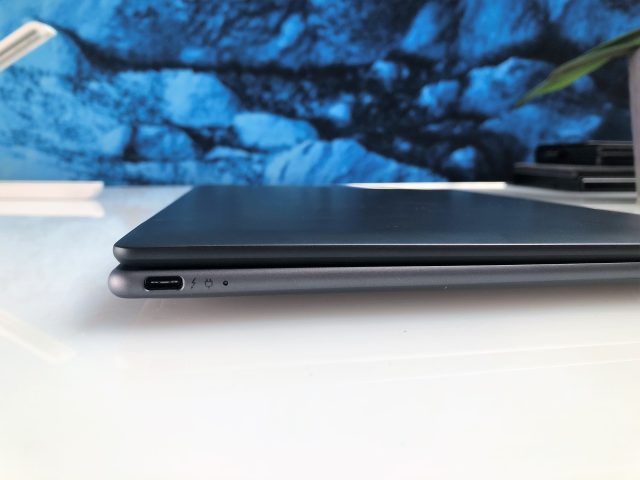 The laptop has three USB-C ports, including two Thunderbolt 4.