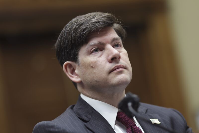 FCC Commissioner Nathan Simington sitting in front of a microphone at a Congressional hearing.