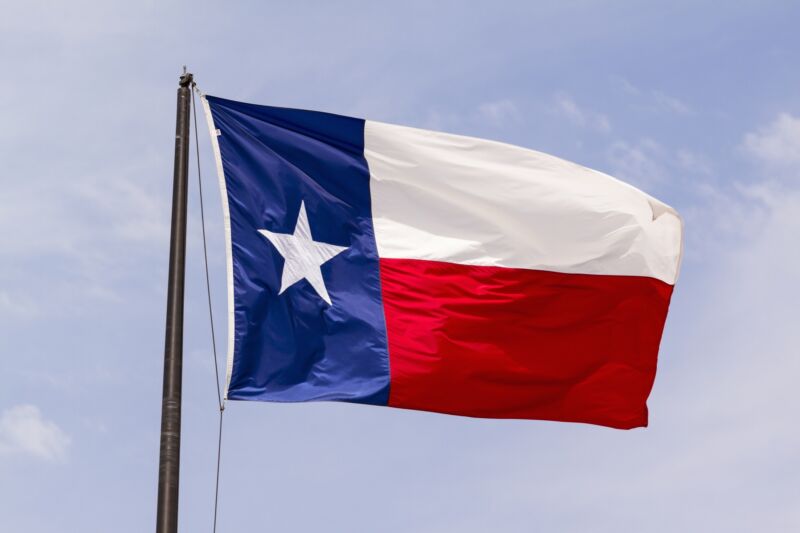A Texas state flag blowing in the wind.