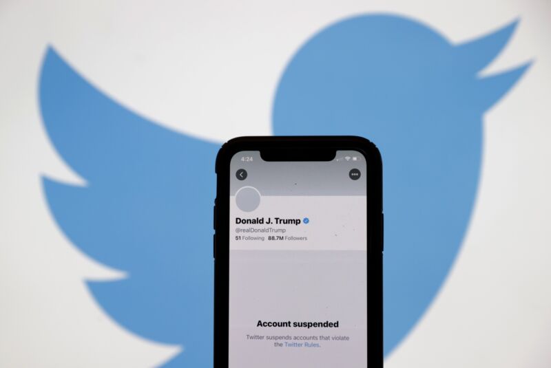 The suspended Twitter account of former US President Donald Trump appears on an iPhone screen