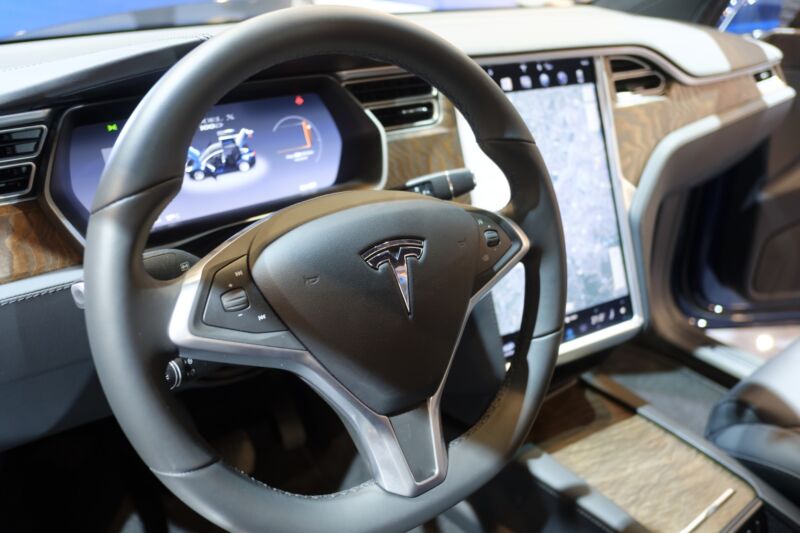 The interior of a Tesla Model X seen at a car expo.