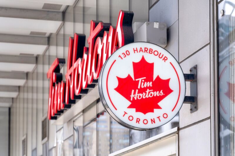 Outside view of a Tim Hortons restaurant in Toronto shows the Tim Hortons logo and a maple leaf.