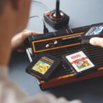The Lego Atari 2600 comes with a moving joystick and three replica cartridges that fit into the system.
