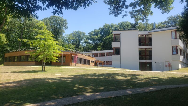 Image of buildings in a wooded environment.