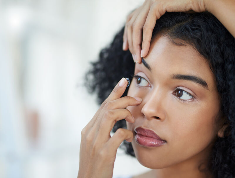 Woman putting in a contact lens