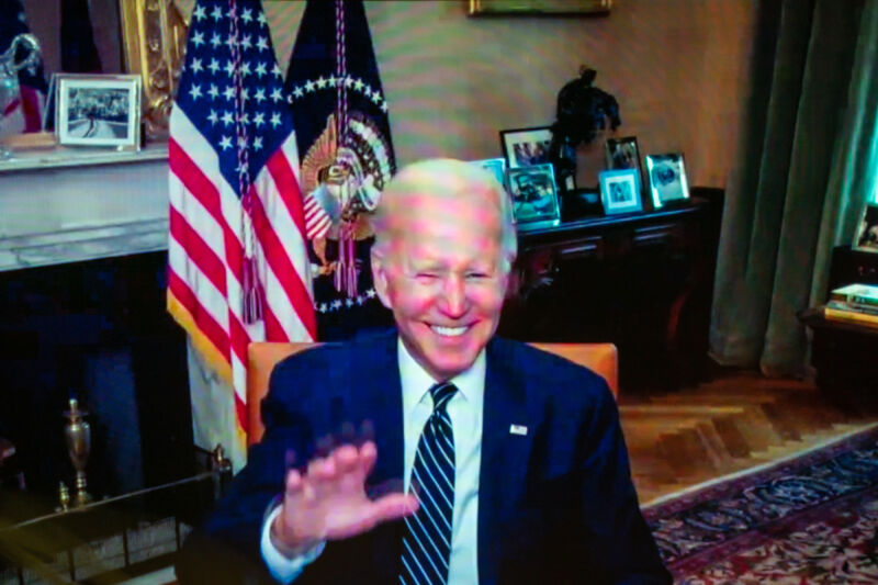 US President Joe Biden waves from his isolation following a virtual meeting on July 26, 2022.