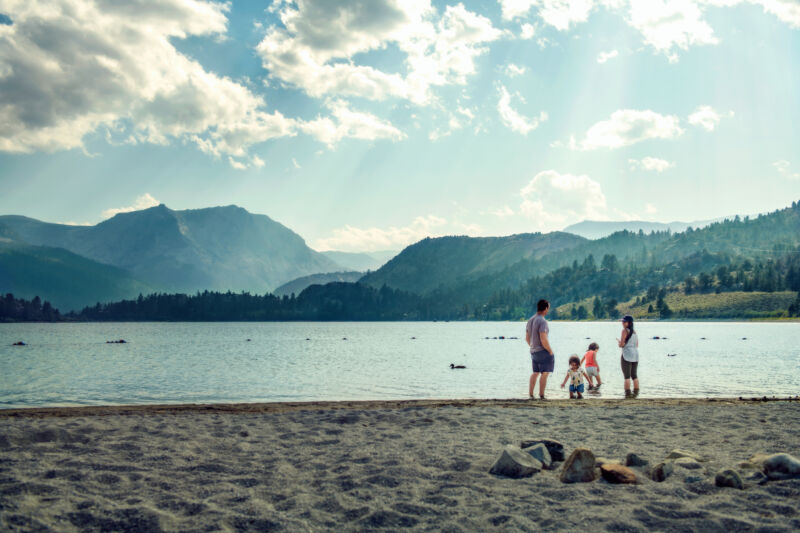 Image of people in front of a mountain lake.